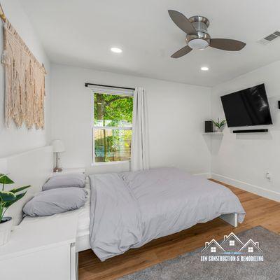 Embrace the ultimate in relaxation and style with this chic white bedroom retreat, complete with a sleek TV