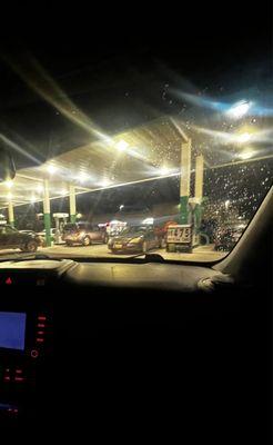 Golden gate gas station with every pump having 2-3 cars.