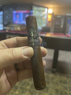 Enjoying one of the many cigars available here while waiting for a cut!