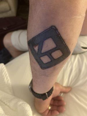 Husband's logo on back of his arm.