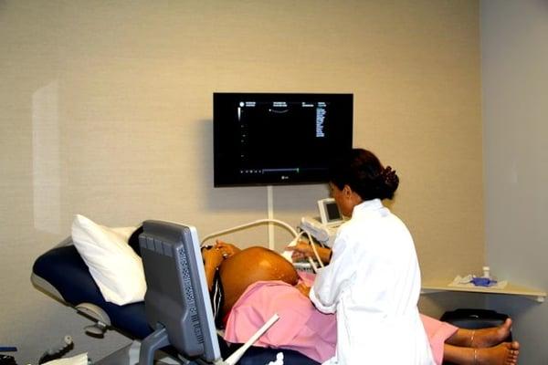 OBGYN Dr. Bhadauria performing an ultrasound on an expecting patient