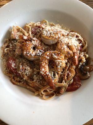 Capellini pasta with shrimp, artichokes, mushrooms and tomatoes with a fresh tomato, garlic herb sauce