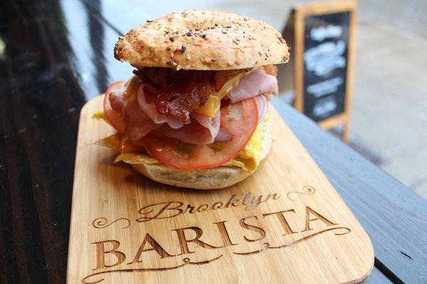 Everything on everything.
(Served on a everything bagel, bacon, egg, cheese, ham, tomatoes, and onion.)