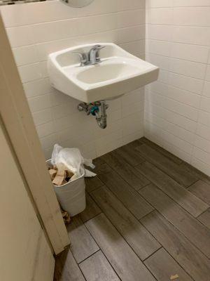 Uncovered diaper filled trash in bathroom