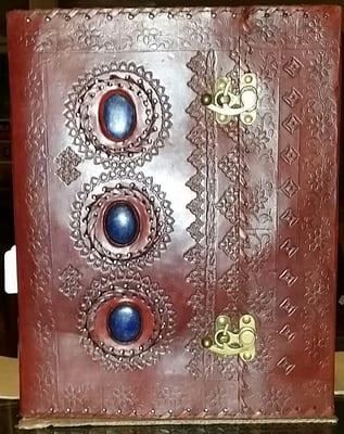 10 X 13 leather journal with 300 pages of hand made paper. 3 pieces of Lapis on cover.