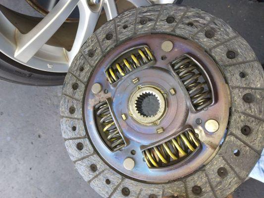 Clutch disk fouled by oil and transmission fluid.