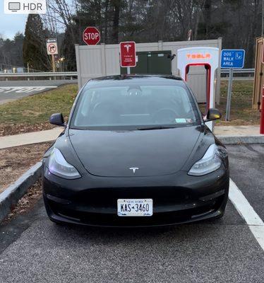 Car parked at a Tesla charger.