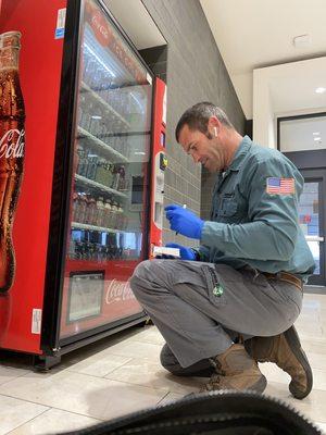 Versa-Tech® Founder Jason Baacke on a commercial service call checking insect traps and treating vending area