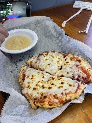 Kids cheese pizza with side of applesauce