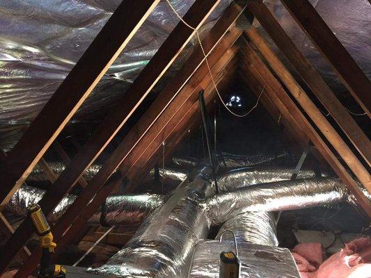 Installing two five ton units and duct work above ceiling.