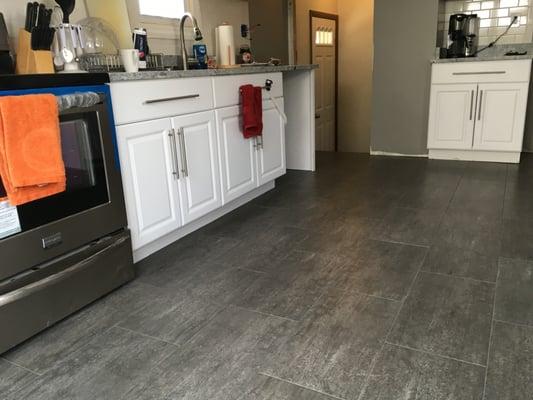 Engineered stone floor helps make the new cabinets pop within this newly remodeled kitchen. Bedford, OH