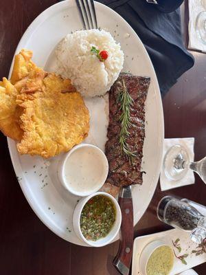 Baby Churrasco with Tostones and white Rice. 2 sides of sauces.