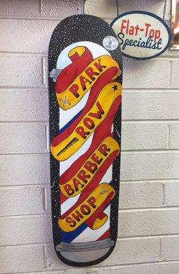 Cool painted skateboard with business sign on it.