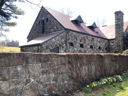 The carriage house is charming in and of itself, as the main house on the hill watches over it.