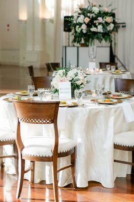 Estate table flowers and candles and reception table centerpieces by UFE. Photo by Leigh Wolfe Photography. Venue: Atlanta History Center.