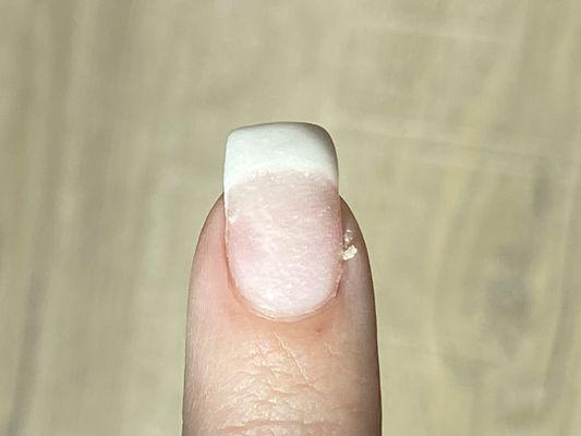 Huge hang nail she couldn't bother to clip and lumpy/uneven/thick attempt to fix her mistake