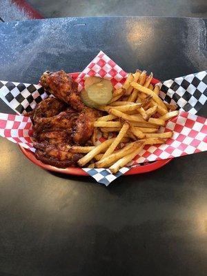 Our Mesquite Smoked Wings tossed in Bbq sauce with a side of  Fries.