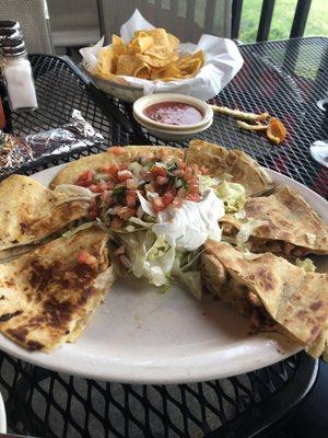 Mexican pizza minus one piece. This is the large one comes with lettuce, pico guac and sour cream.