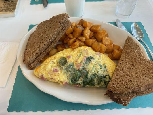 Made to order omelet with multi grain bread and choice of potatoes or fruit which I love.