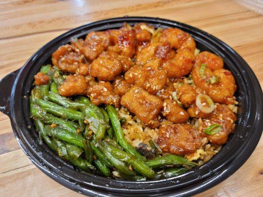 A plate with 3 entries: garlic soy green beans, sesame chicken, firecracker shrimps