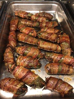 Brisket and cream cheese stuffed jalapeño poppers wrapped in bacon.