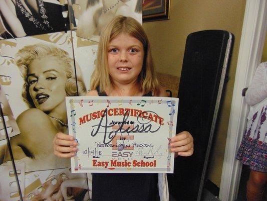 Alissa, our gifted piano student poses for a picture after performing.