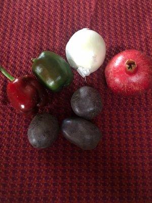 Purple potatoes, bell peppers, onion and pomegranate from My Girlfriends Garden.