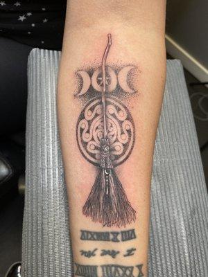 Witchs broom tattoo with pagan symbols