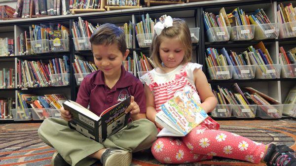 Elementary students enjoying reading time.