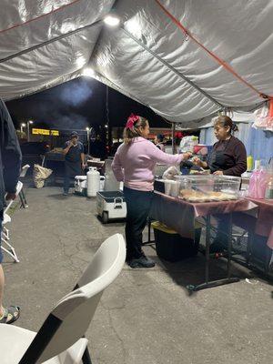 Under the tent. Customers are nicely greeted and menu explained.