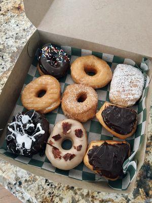 Cookies & Cream, Maple Bacon, Boston Cream, Chocolate w/ Sprinkles, Glazed, Cinnamon Sugar, Powdered Cream -- all yeast doughnuts