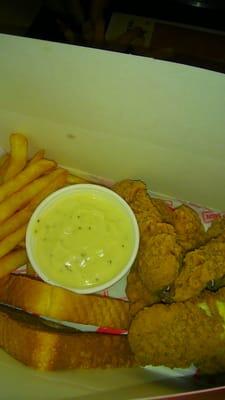 Nice freshly hot made chicken strips with gravy and toast.