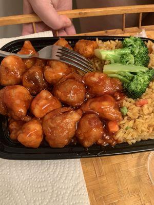 A staple right on top of her Orange Chicken