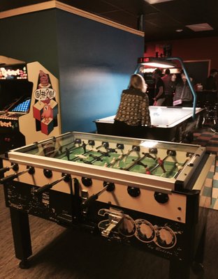 Foosball, air hockey, and ping pong in the back.