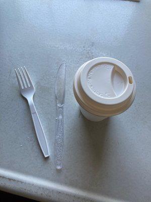 Plastic utensils and plastic coffee lid. No option for "for here" coffee cup.