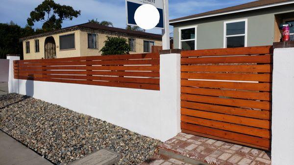 Block wall with white stucco, stained wood privacy fence and door in the Chula Vista area.