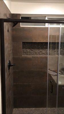 Custom built shower pan and wall niche.