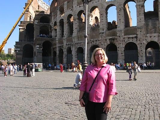 TravelStore's travel consultant Gloria at the Coliseum in Rome, Italy. Europe is our specialty.