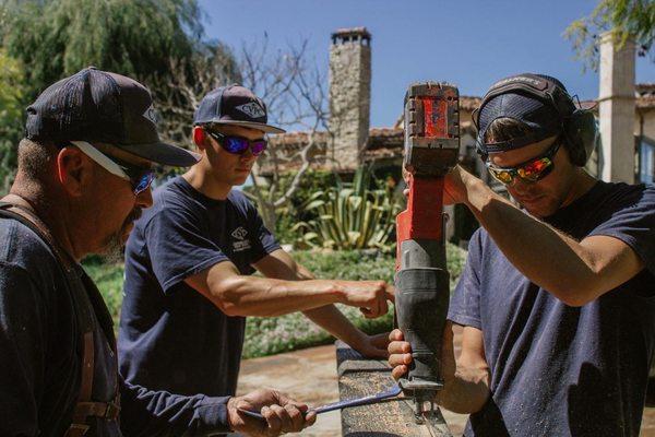 The crew prepping and installing a piece of reclaimed wood in this beautiful home in Rancho Santa Fe!