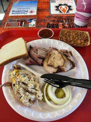 Brisket and smoked turkey with potato casserole and pinto beans.