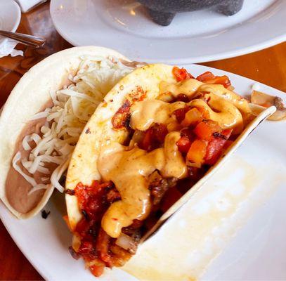 A Grilled Shrimp (Cameron) with Chipotle Crema and a Refried Bean (Frijoles De Casa) Taco