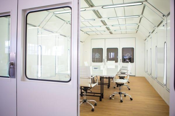 Conference room. The walls and table are all dry erase white boards so you can write on the walls and table during brain storms.