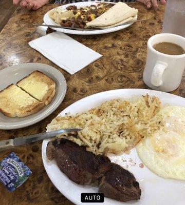 Steak and eggs with hash browns and huevos rancheros.