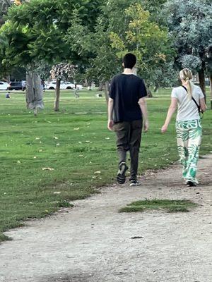 This couple took their dog for a walk, and their dog took a shit. They didn't even bother to pick it up after it.