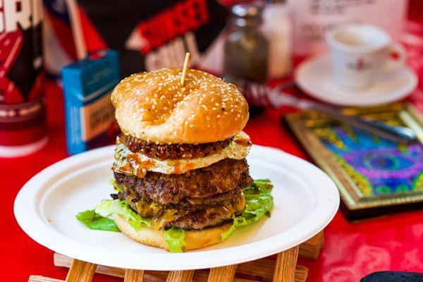 Big boy burger. 3 patties, pastrami, onion ring, fried egg. Delicious