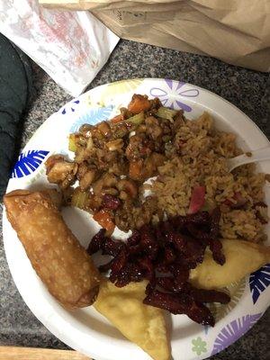 Kung pao chicken combination plate with a side of crab rangoons and boneless ribs.