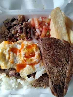 Brazilian Platter with sirloin steak,white rice over pinto beans topped with a fried egg.