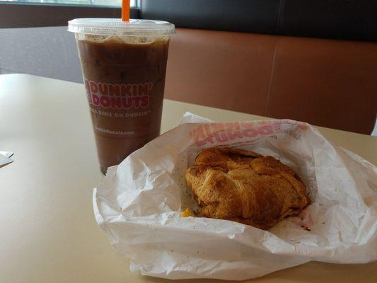 iced macchiato and sausage egg croissant