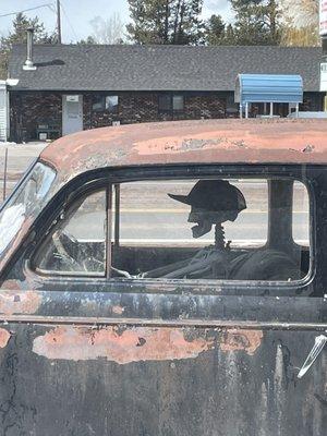 Funky car with skully driver out front.