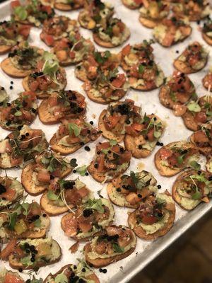 Tomato bruschetta with an Avocado Schmeer topped with balsamic caviar